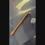 Ergonomic magnetic wooden handle of the PDR Uzbek blending hammer holding a metal knockdown pointer tool during professional auto body repair.
