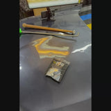 Technician using the checkered titanium tip for metal shrinking