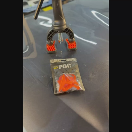 DentPDR assorted crease tab applied to a vehicle body line